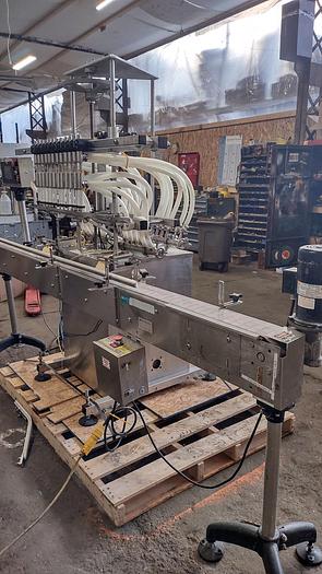 Used Inline Filling Systems - inline 12 spout pressure gravity filler with conveyor