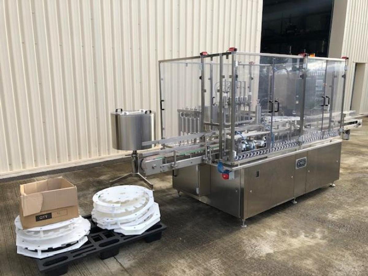 Used OMAS model GL250 Monobloc four head inline liquid filling machine