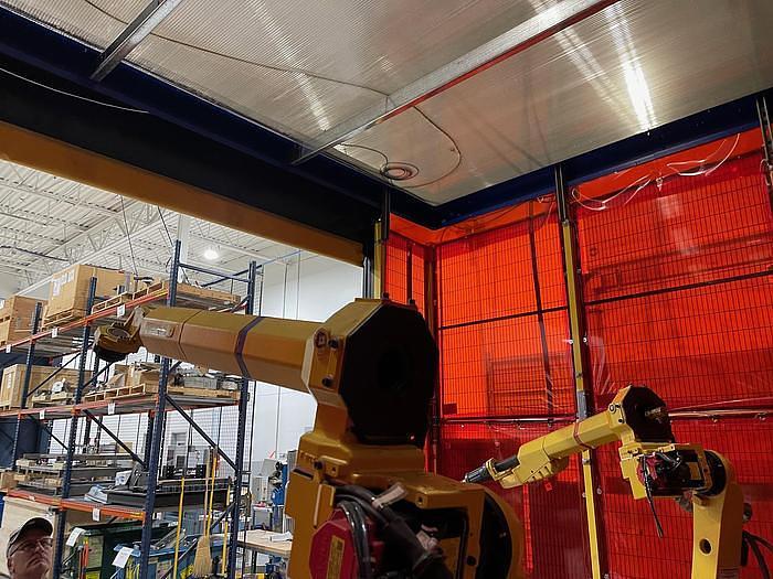 Used FANUC NEVER USED DUAL ARM ARCMATE 100iC/8L ROBOTIC WELDING CELL WITH R30iB CONTROLLERS, ENCLOSURE,     HEADSTOCK/TAIL STOCK, ROBOVENT HOOD
