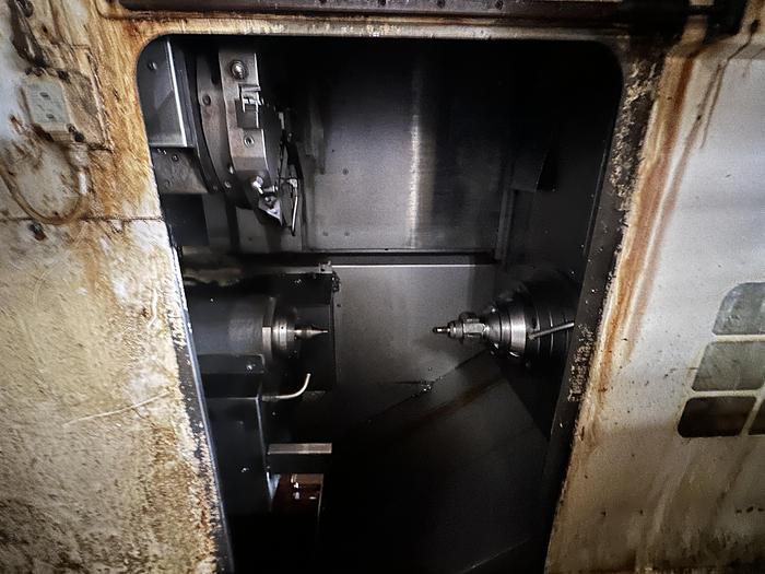 Used FUJI ANW 35 TWIN TURRET CNC LATHE, TAIL STOCK WITH ROBOT LOAD/UNLOAD AND STOCKER TABLES