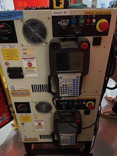 Used FANUC NEVER USED DUAL ARM ARCMATE 100iC/8L ROBOTIC WELDING CELL WITH R30iB CONTROLLERS, ENCLOSURE,     HEADSTOCK/TAIL STOCK, ROBOVENT HOOD