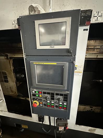 Used FUJI ANW 35 TWIN TURRET CNC LATHE, TAIL STOCK WITH ROBOT LOAD/UNLOAD AND STOCKER TABLES