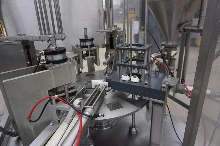 Used Modern Packaging MR Series Rotary cup Filling and Sealing Filling line