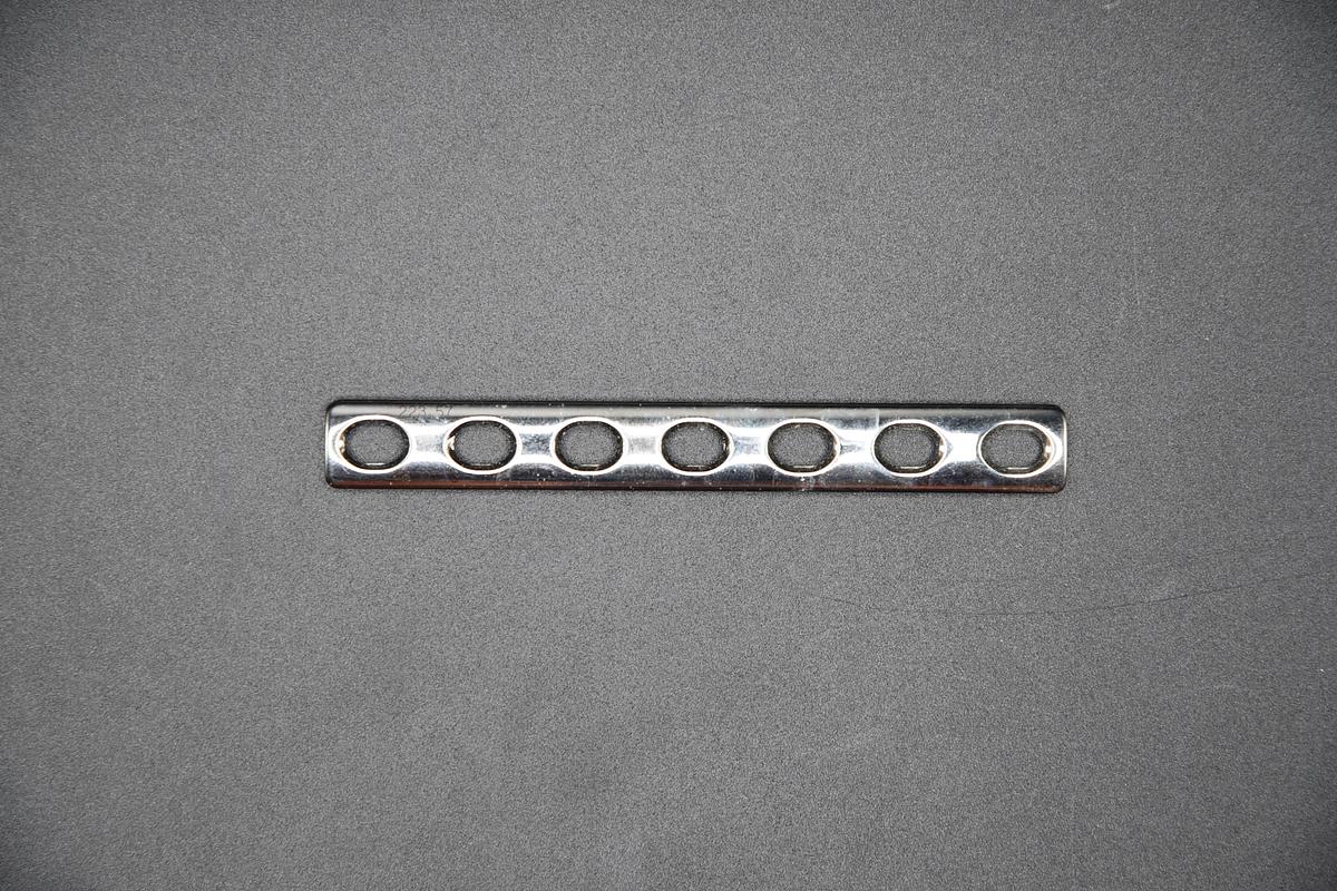 Used DEPUY SYNTHES: 223.57 LC-DCP Plate, 3.5 mm Size, Stainless Steel, 90 L x 11 mm W, 7 Holes