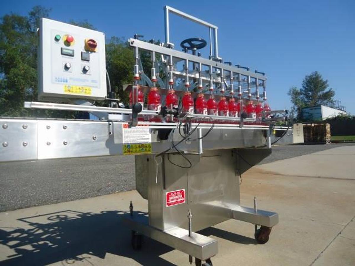 Used Kaps-All Twelve Spout Inline Pressure Filler Model Fa-P