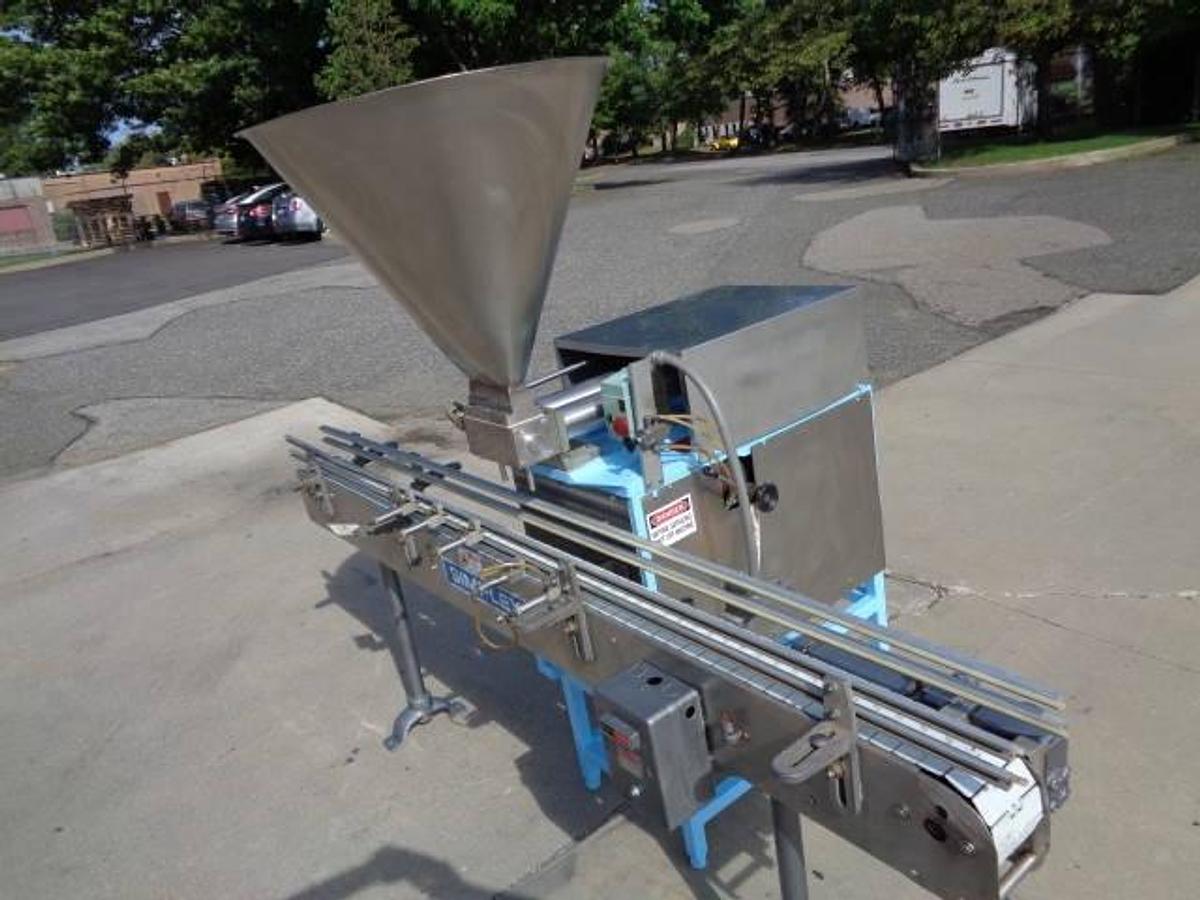 Used Simplex Twin Head Automatic Piston Filler With Indexing Conveyor