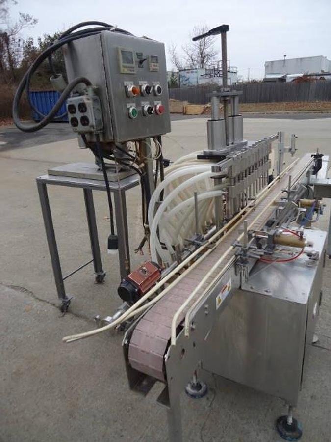 Used Jg Machine Works Twelve Spout Automatic Pressure Gravity Filler