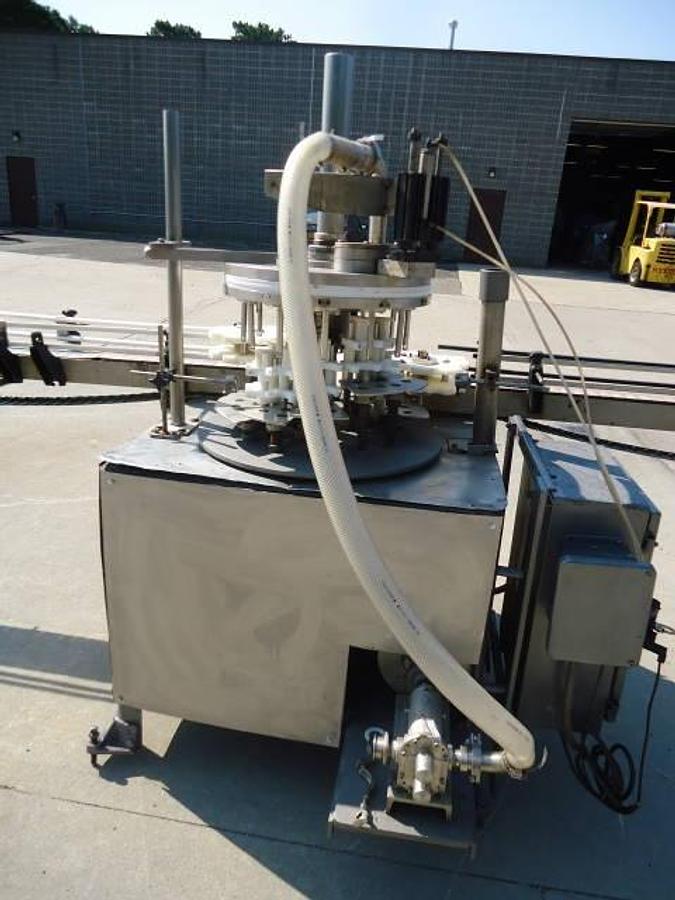 Used MRM Versafil Twelve Spout Rotary Positive Displacement Filler With Conveyor
