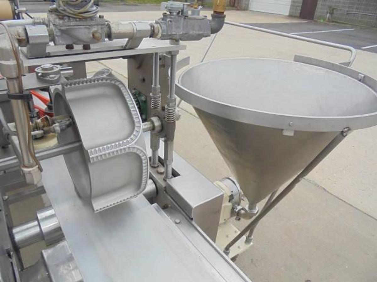 Used Colborne T-28000 Automatic Turnover Pie Machine, tooled currently for Jamaican Beef Patties