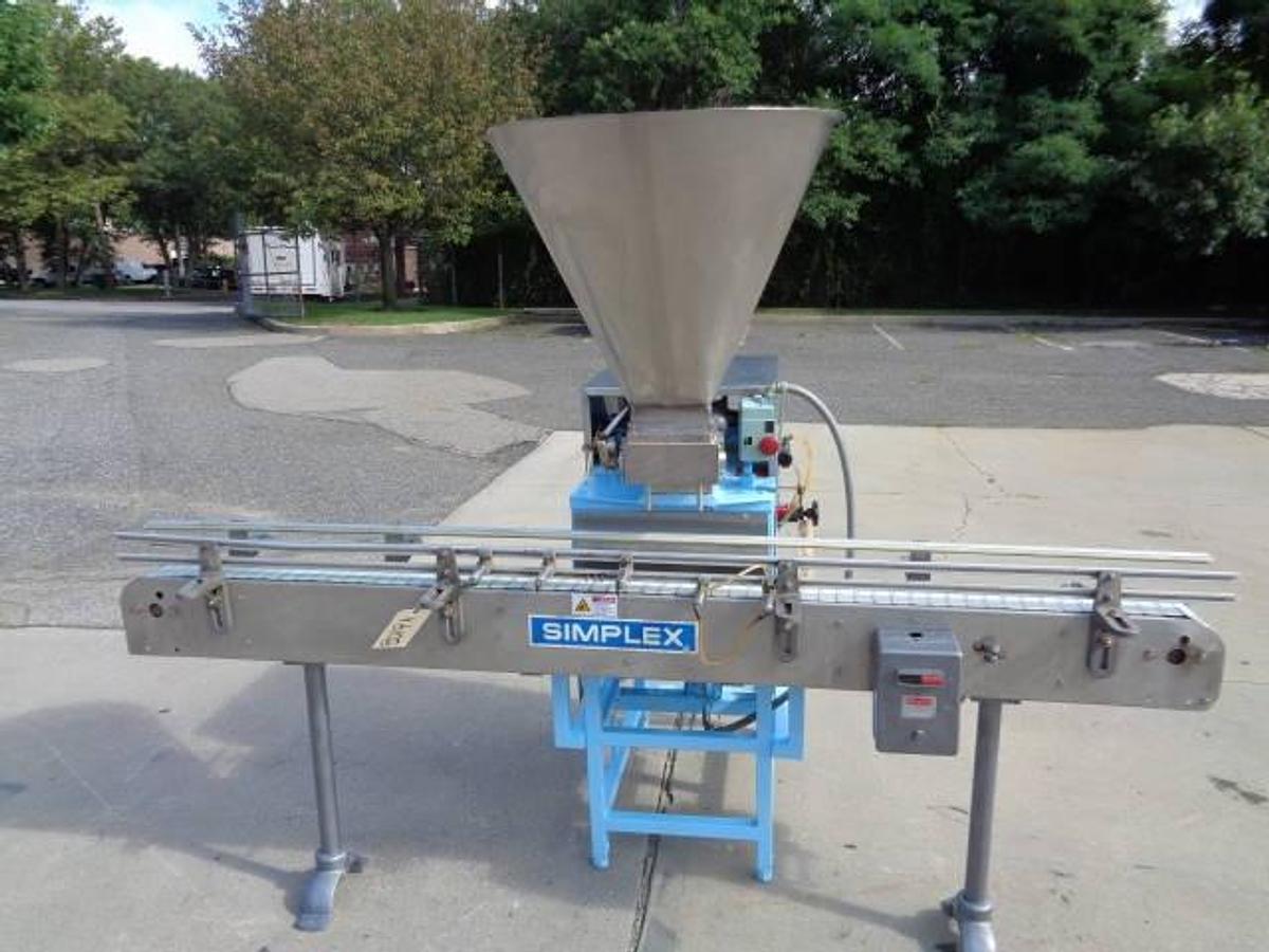 Used Simplex Twin Head Automatic Piston Filler With Indexing Conveyor