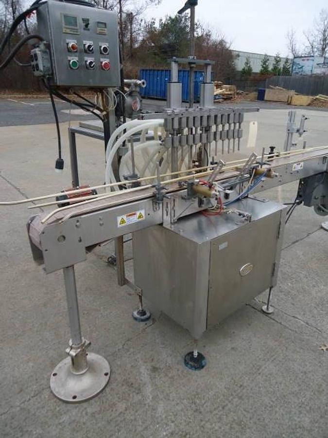 Used Jg Machine Works Twelve Spout Automatic Pressure Gravity Filler