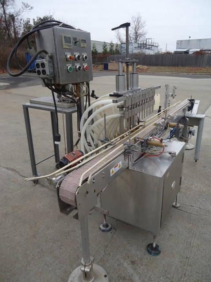 Used Jg Machine Works Twelve Spout Automatic Pressure Gravity Filler