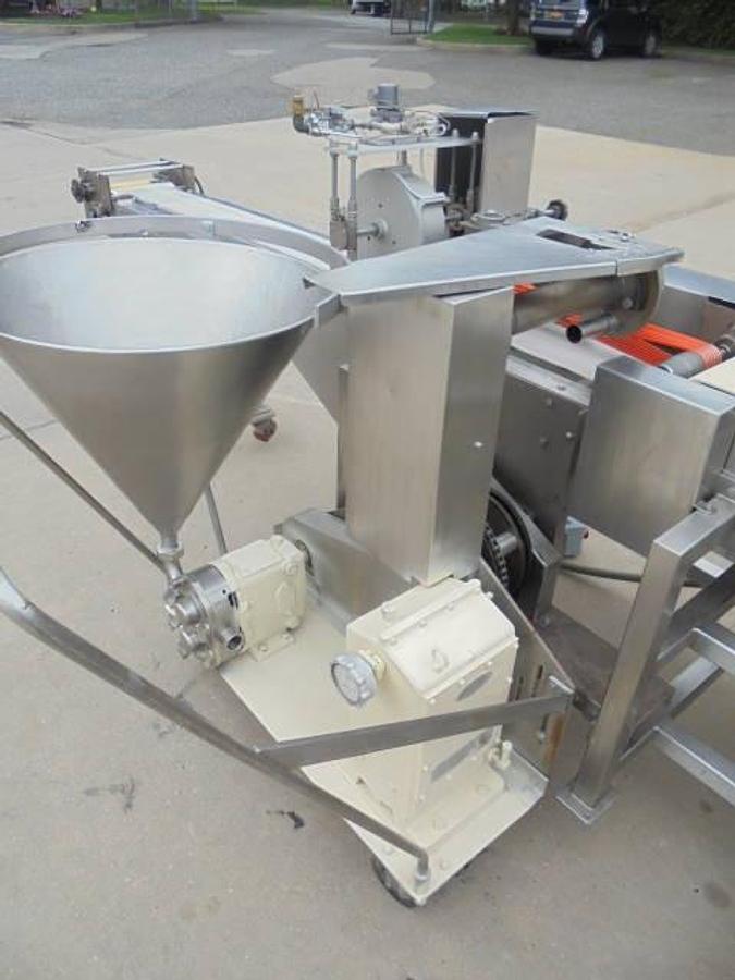Used Colborne T-28000 Automatic Turnover Pie Machine, tooled currently for Jamaican Beef Patties