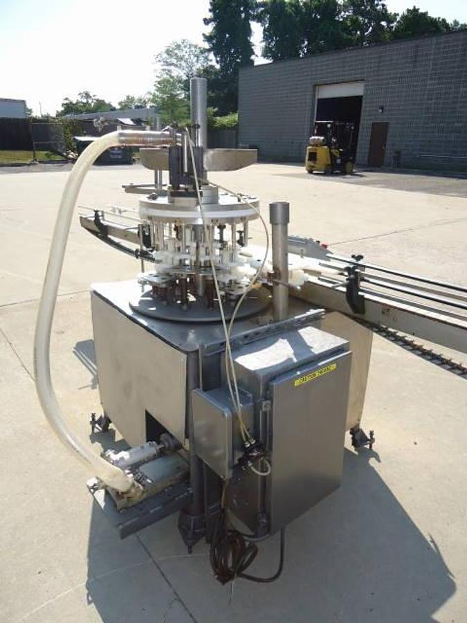 Used MRM Versafil Twelve Spout Rotary Positive Displacement Filler With Conveyor