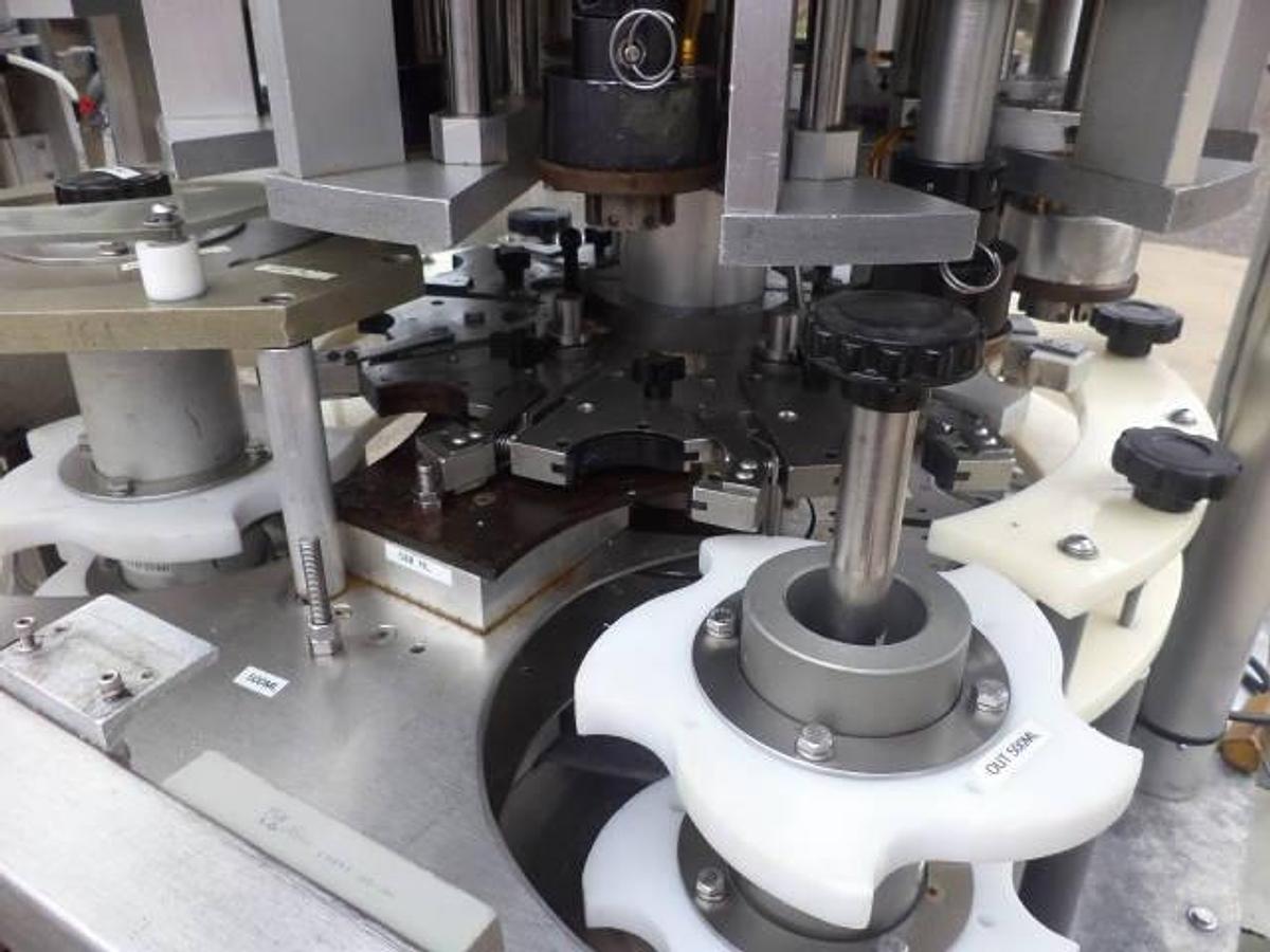 Used New England Machinery Ten Head Rotary Capper With  Feeder/Unscrambler