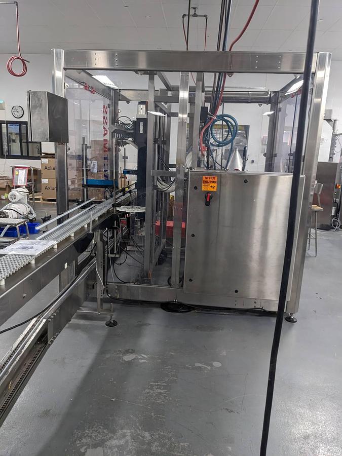 Used Apacks Six Head Automatic Mass Flow Meter Pressure Filling Machine, with conveyor