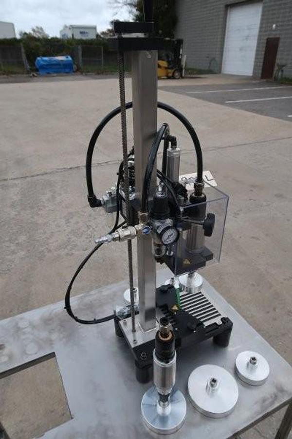 Used Kinex Air Operated Chuck Style Capper with Bench Top Table