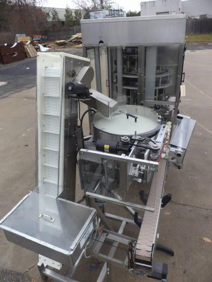 Used New England Machinery Ten Head Rotary Capper With  Feeder/Unscrambler