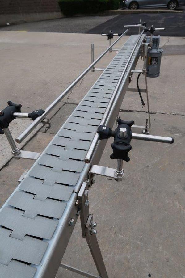 Used 4.5 In. X 16 Ft. Long Motorized Bottle Conveyor, Stainless Steel Frame