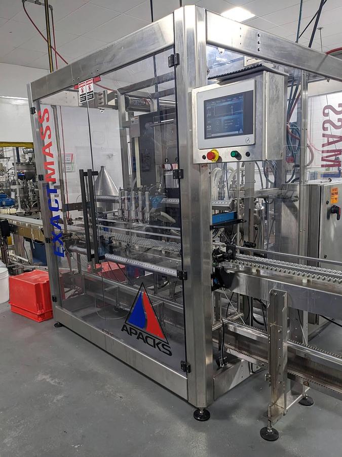 Used Apacks Six Head Automatic Mass Flow Meter Pressure Filling Machine, with conveyor