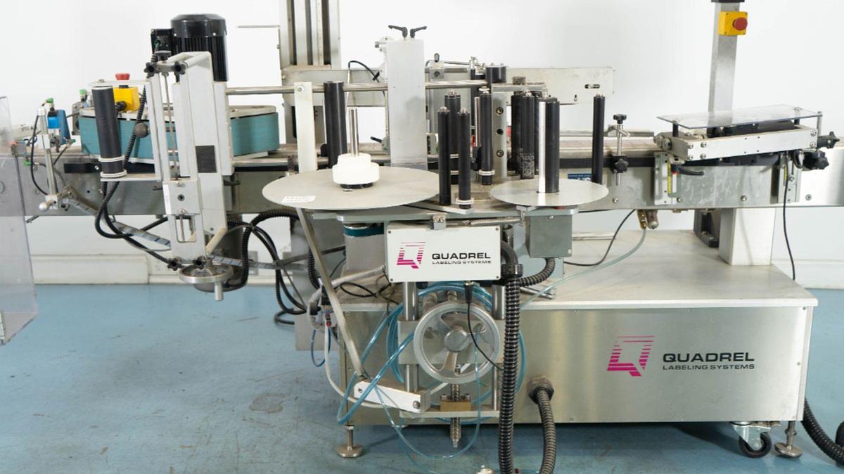 Used Quadrel VersaLine Spot/Wraparound Pressure Sensitive Labeler