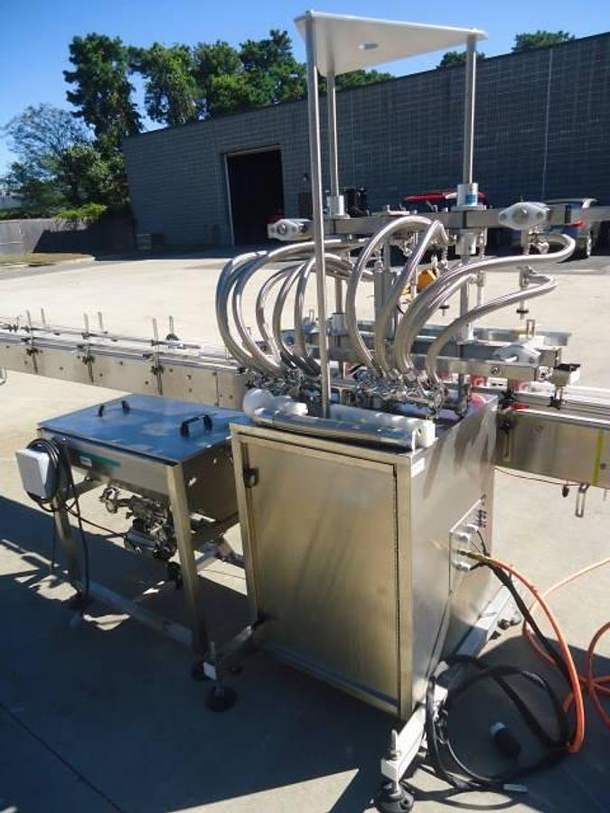 Used Inline Filling Systems Six Head Level Head Overflow Pressure Filler With 20 Ft. Conveyor