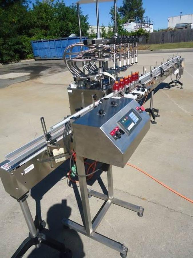 Used Inline Filling Systems Six Head Level Head Overflow Pressure Filler With 20 Ft. Conveyor