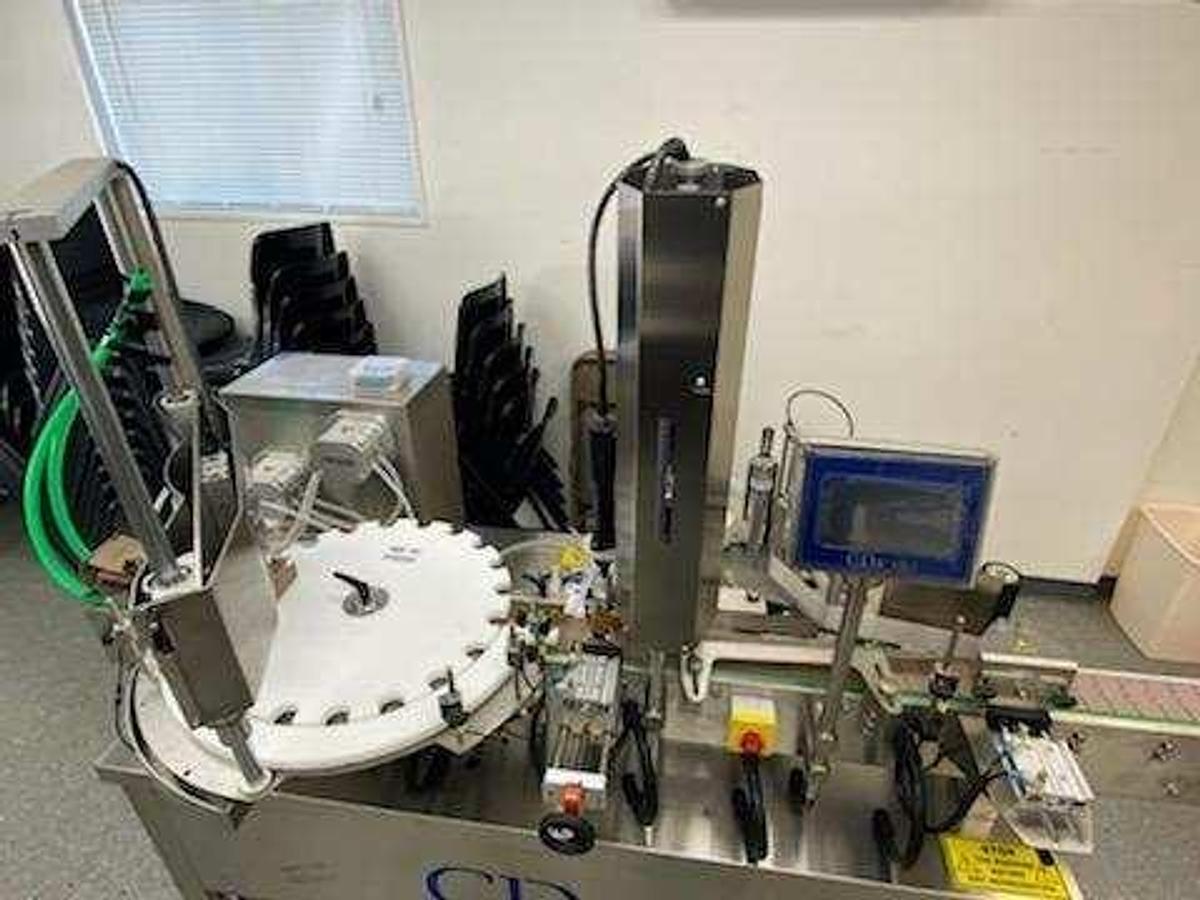 Used CDA Bottling Line with Rotary Tables