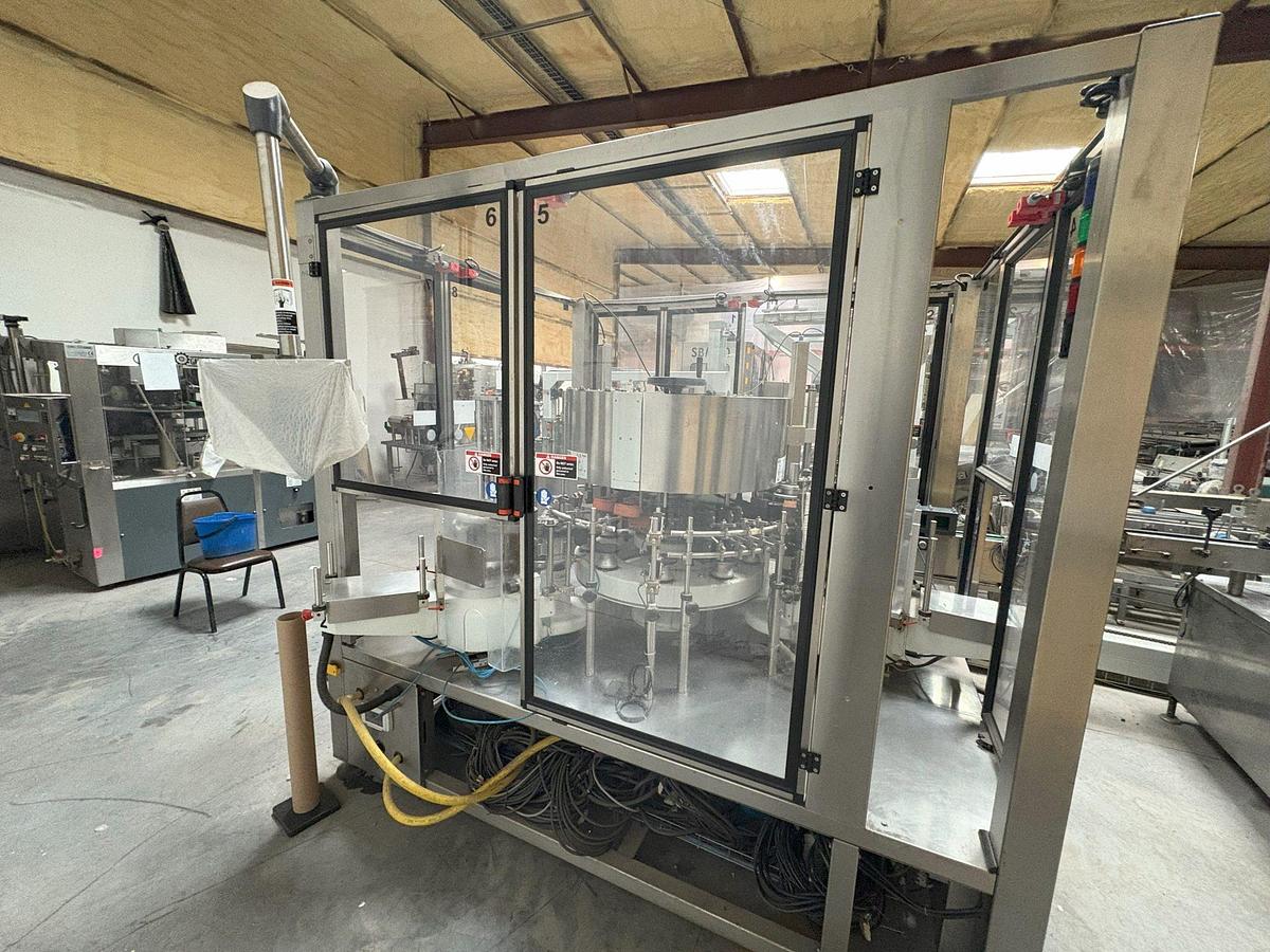 Used Kosme Nine Station Rotary Front, Back and Neck Cold Glue Labeling System
