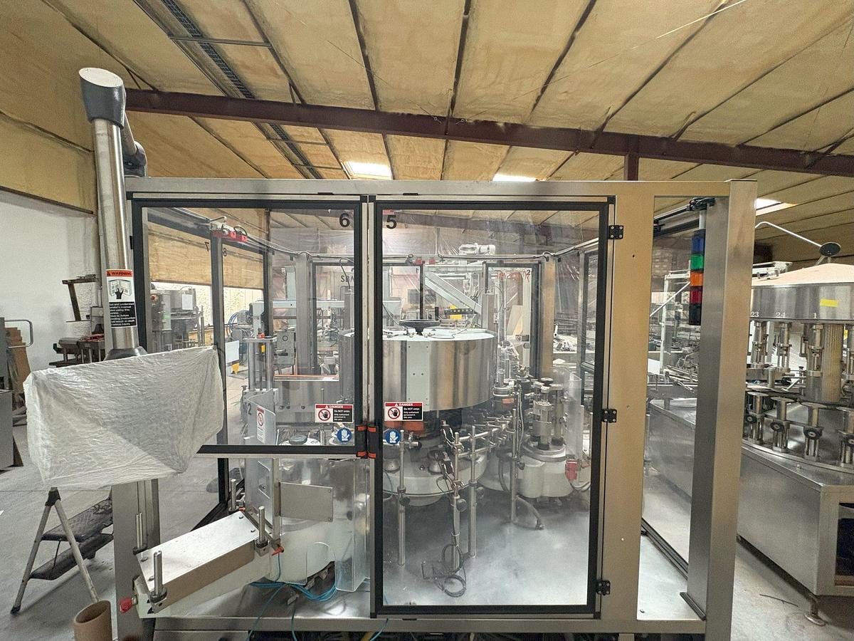Used Kosme Nine Station Rotary Front, Back and Neck Cold Glue Labeling System