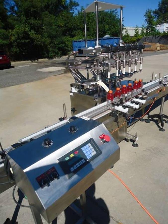 Used Inline Filling Systems Six Head Level Head Overflow Pressure Filler With 20 Ft. Conveyor