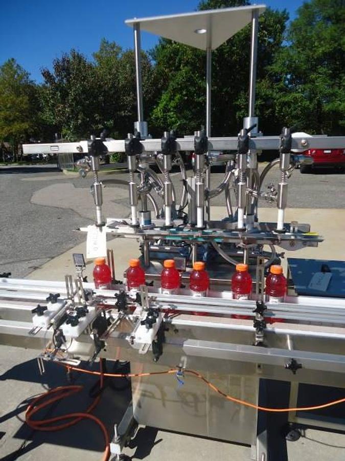 Used Inline Filling Systems Six Head Level Head Overflow Pressure Filler With 20 Ft. Conveyor