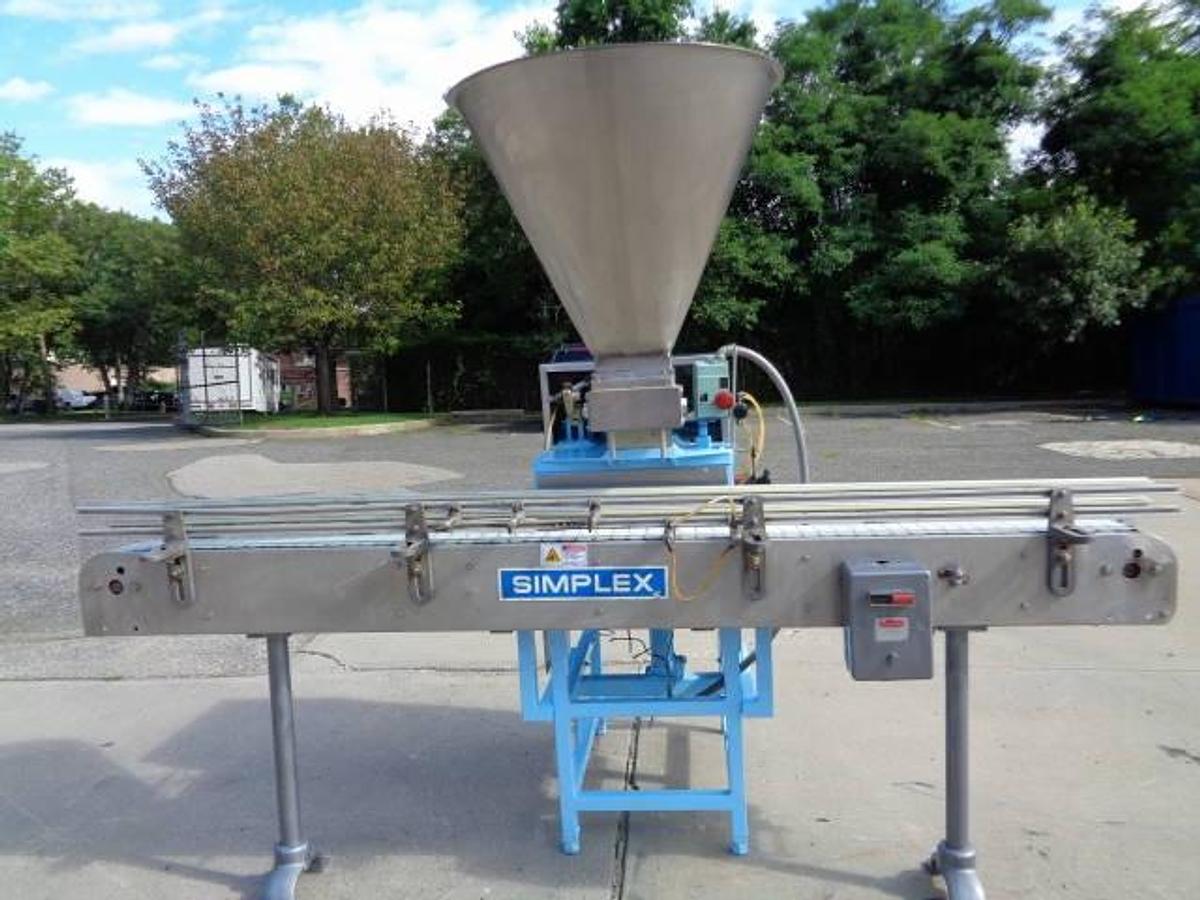 Used Simplex Twin Head Automatic Piston Filler With Indexing Conveyor