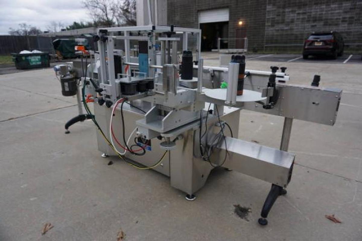 Used Aesus Systems “Eco Wrap Prism” Automatic Pressure Sensitive Spot/Wrap Around Labeler, Stainless Steel