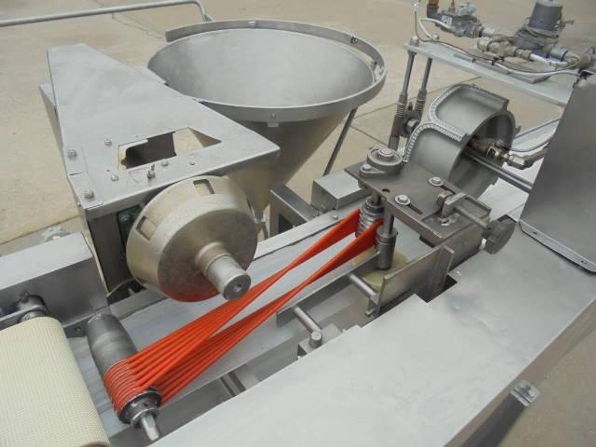 Used Colborne T-28000 Automatic Turnover Pie Machine, tooled currently for Jamaican Beef Patties