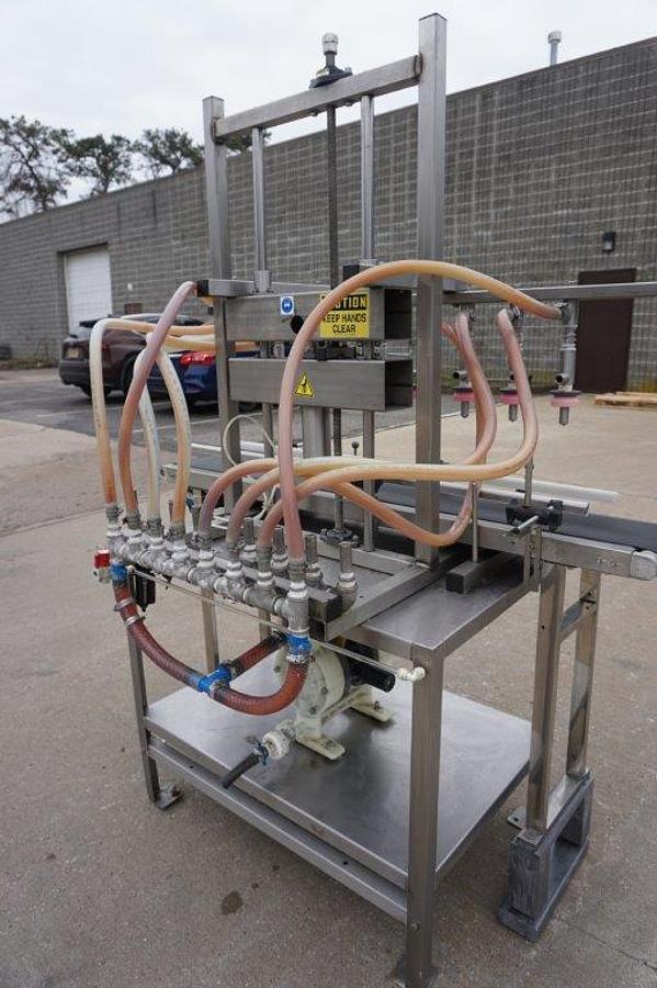 Used 8 Spout Straight Line Liquid Overflow Filler With Diaphragm Pump