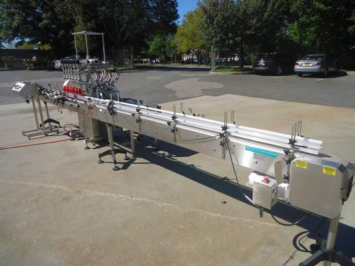 Used Inline Filling Systems Six Head Level Head Overflow Pressure Filler With 20 Ft. Conveyor
