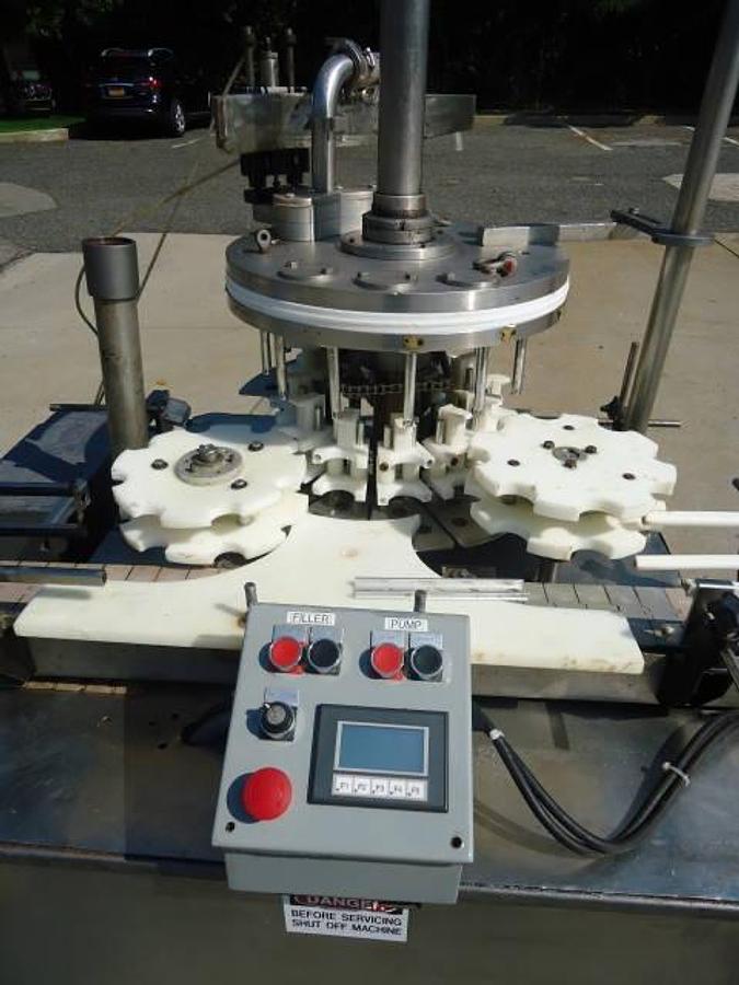 Used MRM Versafil Twelve Spout Rotary Positive Displacement Filler With Conveyor