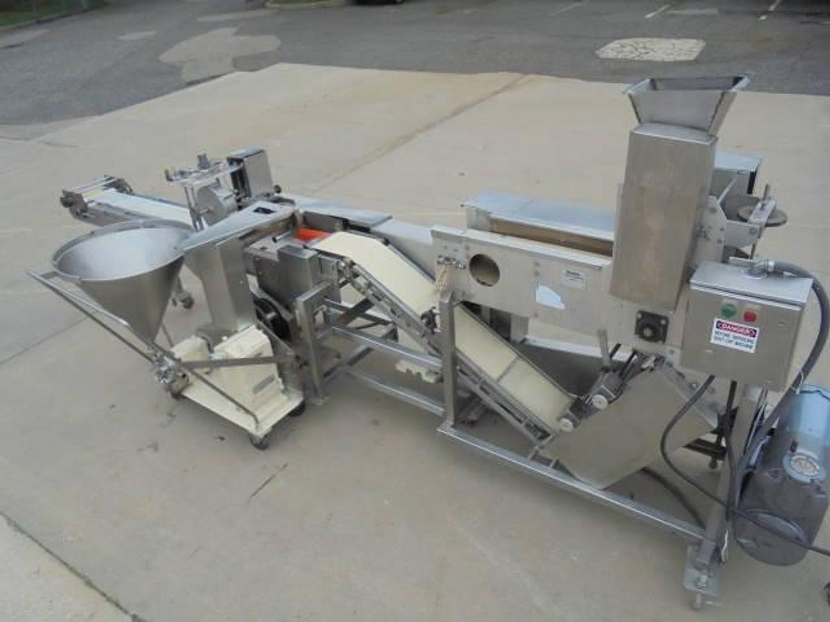 Used Colborne T-28000 Automatic Turnover Pie Machine, tooled currently for Jamaican Beef Patties