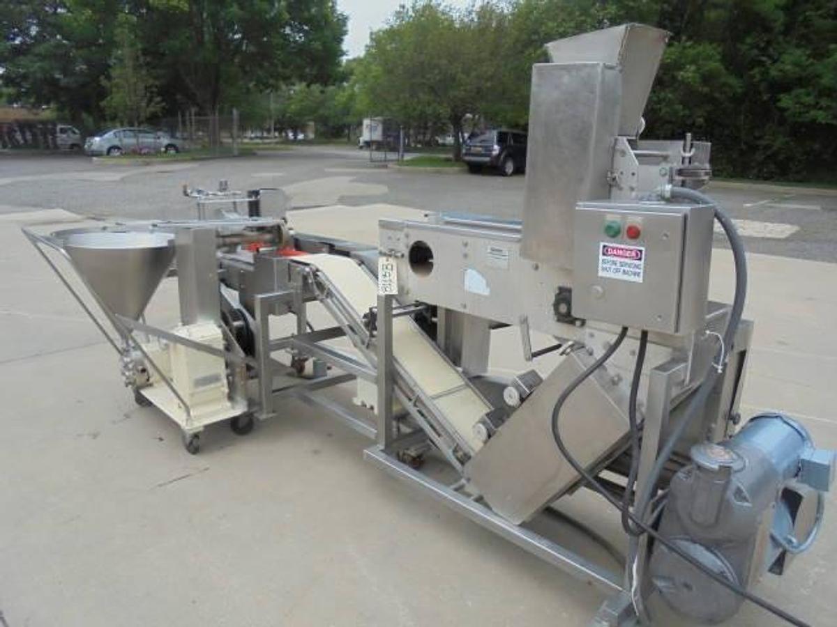 Used Colborne T-28000 Automatic Turnover Pie Machine, tooled currently for Jamaican Beef Patties