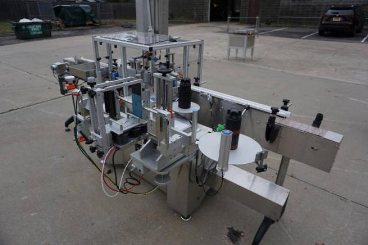 Used Aesus Systems “Eco Wrap Prism” Automatic Pressure Sensitive Spot/Wrap Around Labeler, Stainless Steel