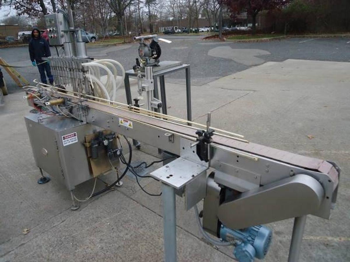 Used Jg Machine Works Twelve Spout Automatic Pressure Gravity Filler