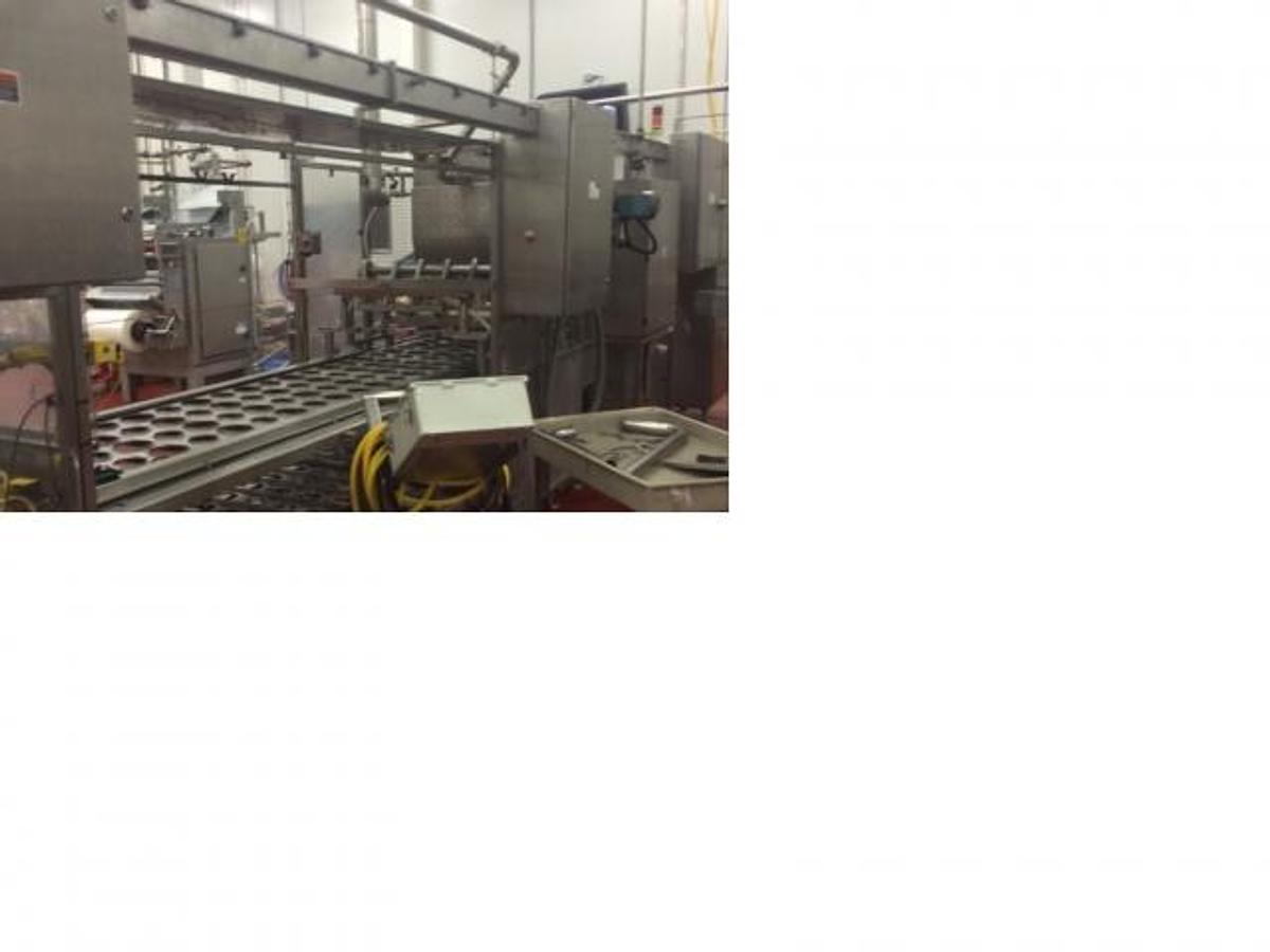Used Osgood 4- lane cup filling and sealing machine