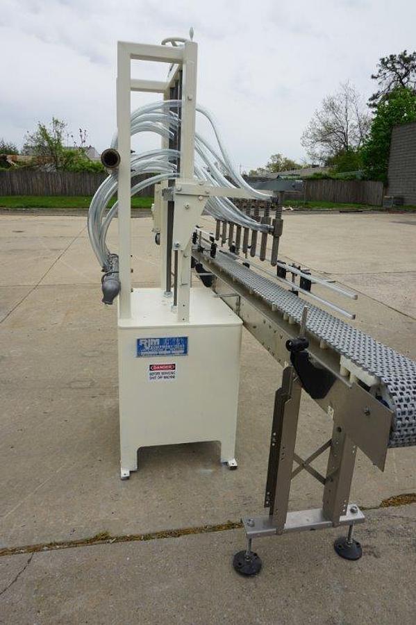 Used RJM 8 Spout Straight Line Liquid Filling Machine, Pressure Gravity Nozzles