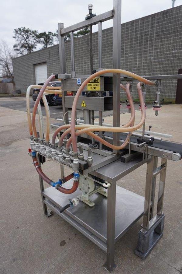 Used 8 Spout Straight Line Liquid Overflow Filler With Diaphragm Pump