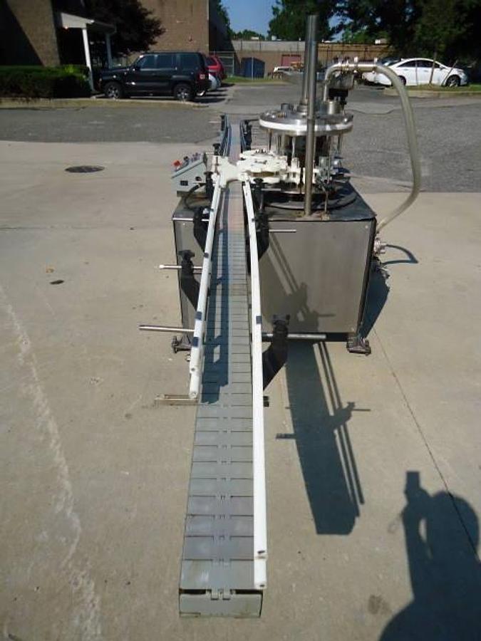 Used MRM Versafil Twelve Spout Rotary Positive Displacement Filler With Conveyor