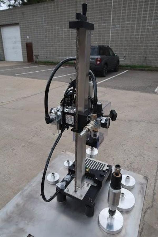 Used Kinex Air Operated Chuck Style Capper with Bench Top Table