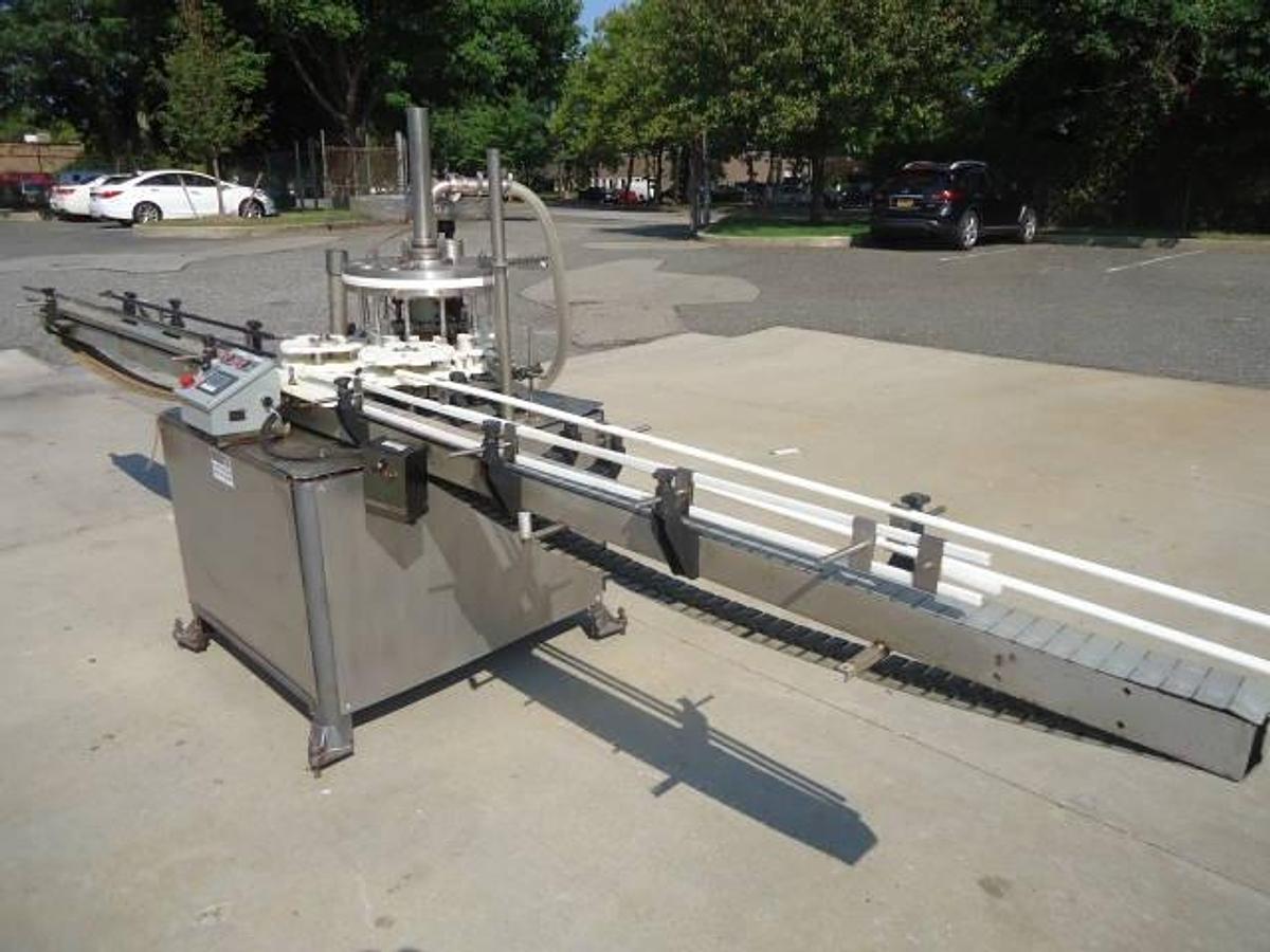 Used MRM Versafil Twelve Spout Rotary Positive Displacement Filler With Conveyor