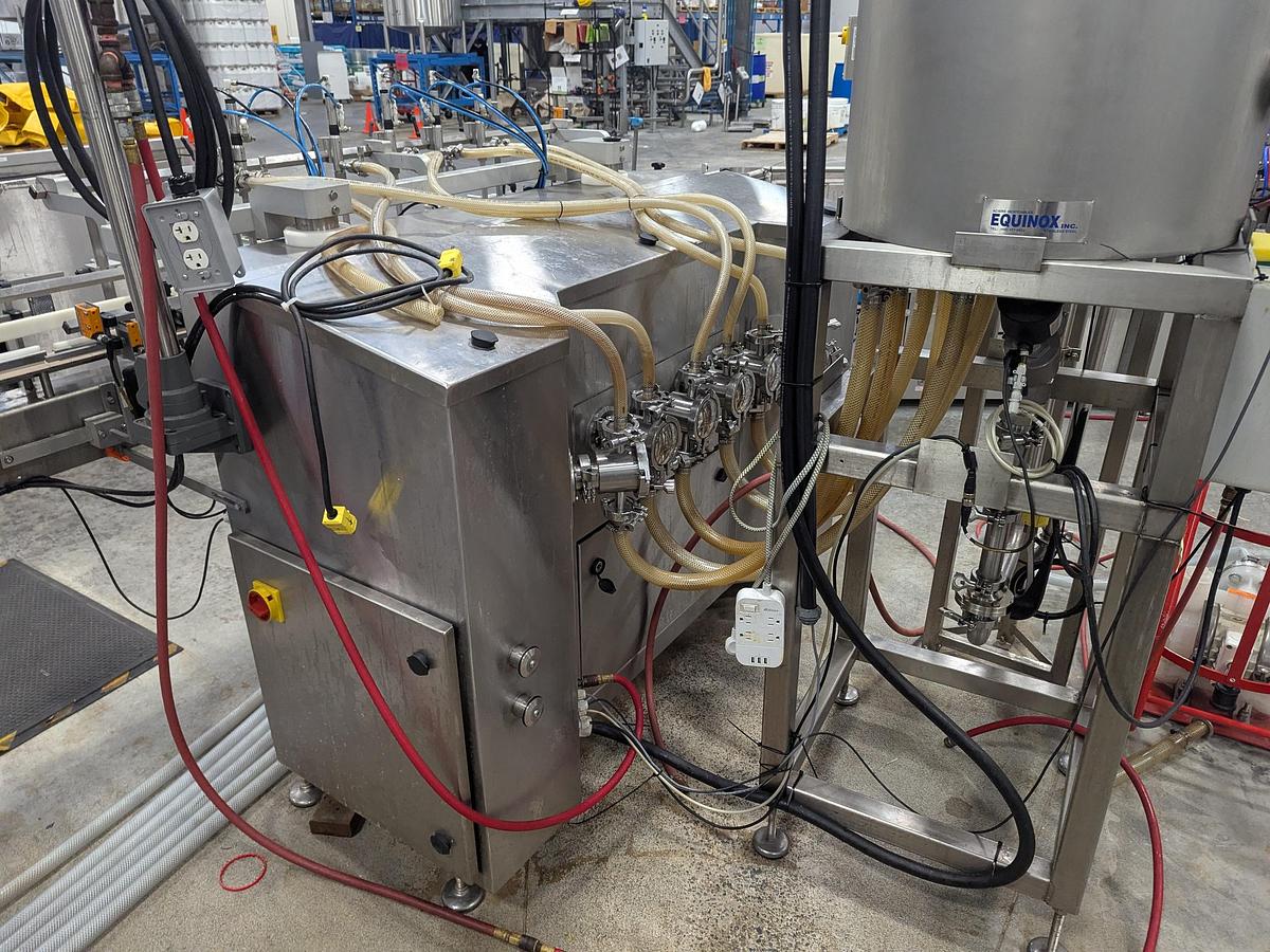 Used Aesus 6-Head Filling Line with Descrambler. Labeler, Filler, Capper, Induction Sealer & Accumulation Table