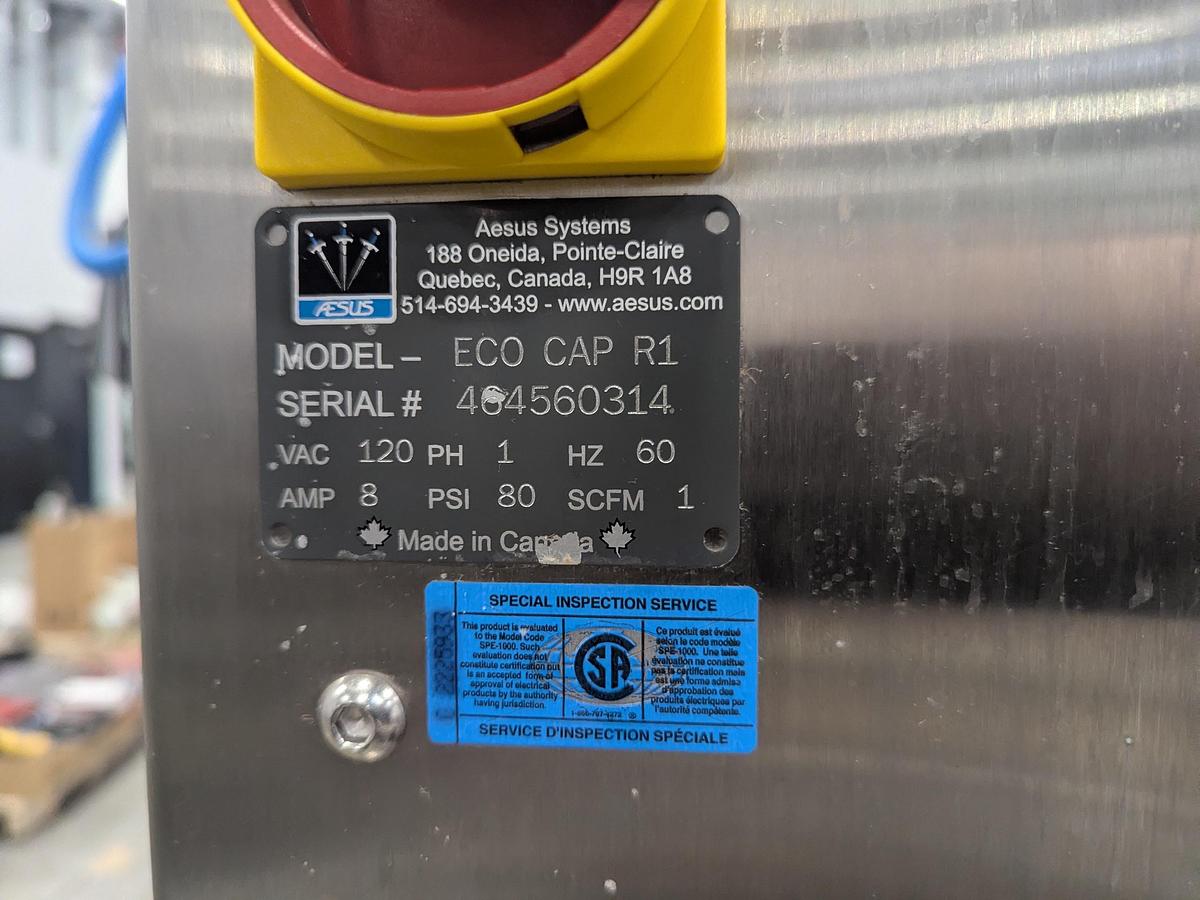 Used Aesus 6-Head Filling Line with Descrambler. Labeler, Filler, Capper, Induction Sealer & Accumulation Table